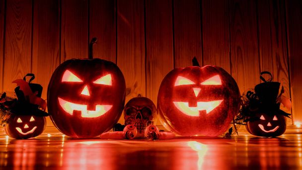 Halloween pumpkin head jack lantern over red wooden shining background - Photo, Image