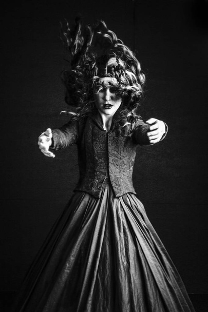 Spooky Victorian woman in a black ensemble - Foto, Imagen