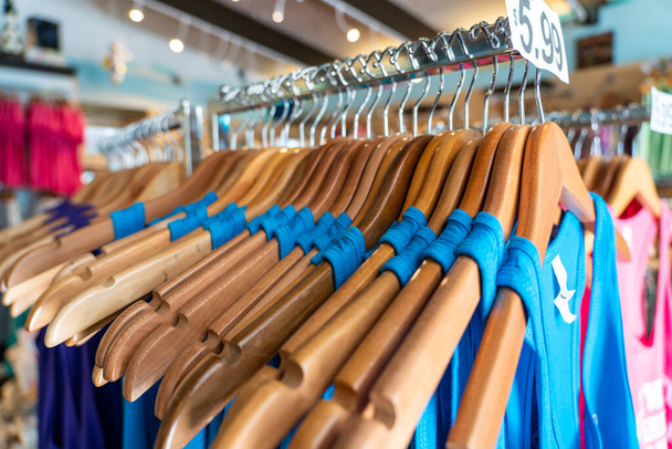 Close-up of blue t-shirts hanging on cloth hanger - Photo, Image