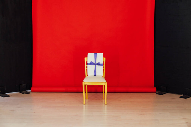 red black background room and golden chair with gift - Photo, Image