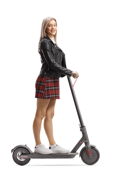 Beautiful young urban woman on an electric scooter - Foto, Imagen