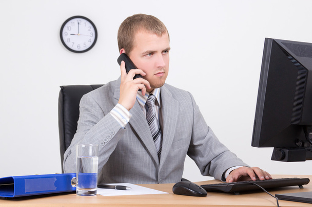 Biznesmen rozmawiający przez telefon w biurze - Zdjęcie, obraz