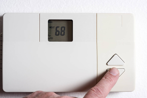 Lowering the temperature on a thermostat - Photo, Image
