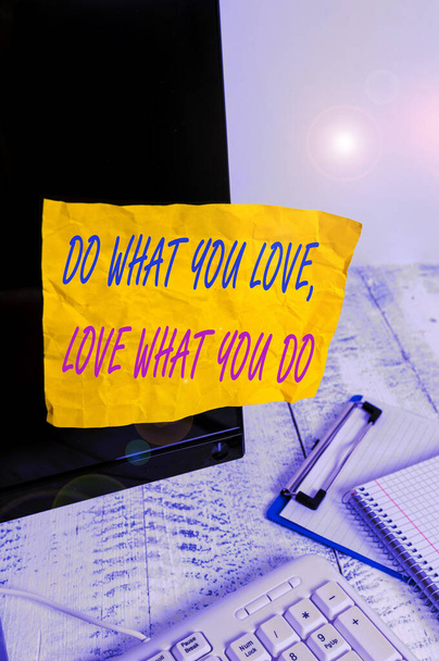 Conceptual hand writing showing Do What You Love Love What You Do. Business photo showcasing you able doing stuff you enjoy it to work in better places then Note paper taped to black screen near keybo - Photo, Image