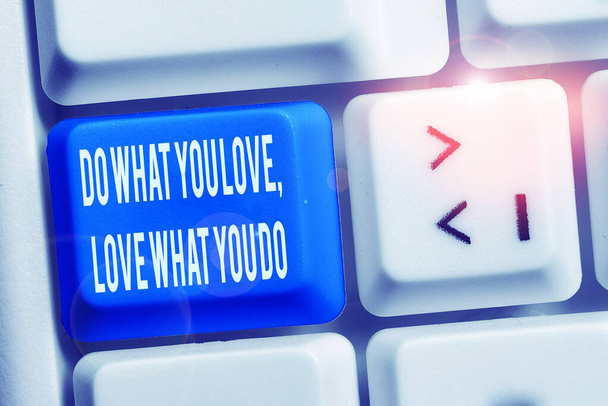 Text sign showing Do What You Love Love What You Do. Conceptual photo you able doing stuff you enjoy it to work in better places then White pc keyboard with empty note paper above white background key - Photo, Image