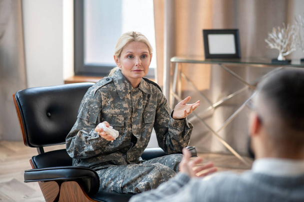 Blonde military mid-aged woman attending psychologist regularly - Foto, imagen