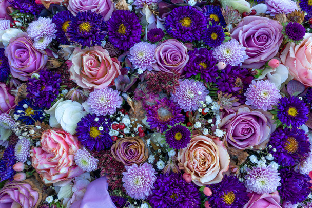 Slightly withered purple flower arrangement in close-up from above - Photo, Image