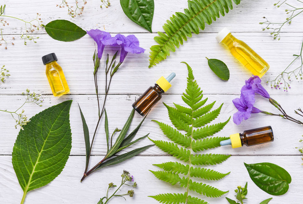 Aromatherapy herbal oil bottles aroma with flower leaves herbal  - Foto, imagen