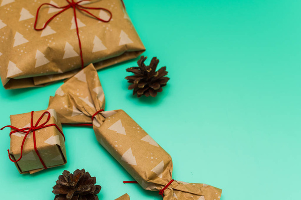 Packed gifts in kraft paper on blue background - Photo, Image