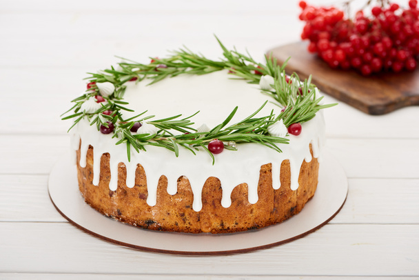 christmas pie with rosemary and viburnum berries on white wooden table   - Photo, Image