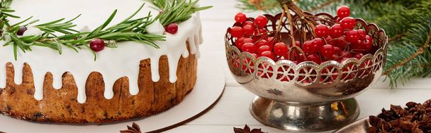 christmas pie, anise star seeds and viburnum berries on white wooden table with spruce branches - Photo, Image