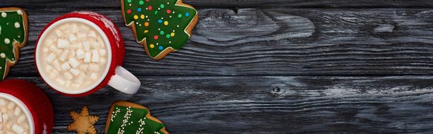 vista superior de cacao con malvaviscos y galletas de árbol de Navidad en mesa de madera oscura
  - Foto, Imagen