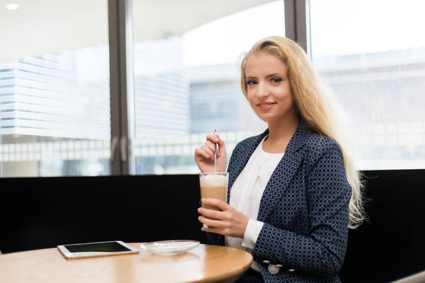 Beautiful woman having a coffee in a cafe - Zdjęcie, obraz
