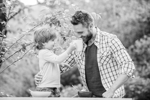 happy fathers day. Little boy with dad have breakfast. son and father eating milk porridge. childhood happiness. Baby food. Happy family together. healthy food and dieting. Dairy products. Detox diet - Fotoğraf, Görsel
