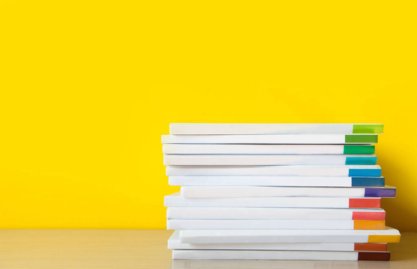 Stack of white books on colorful background.  - Photo, image