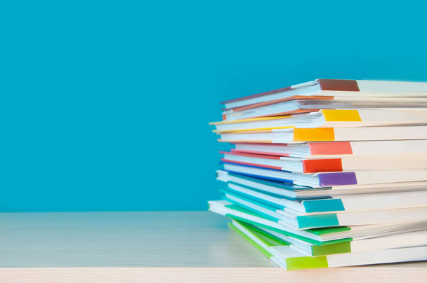 Stack of colorful books on color background.  - 写真・画像