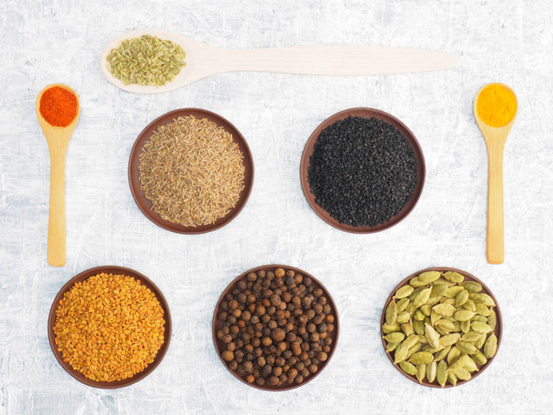 Different spices and herbs set on concrete background in clay pl - Foto, Imagen
