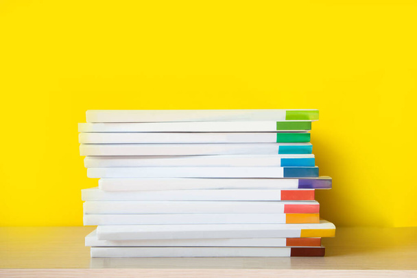 Stack of colorful books on color background.  - Fotoğraf, Görsel