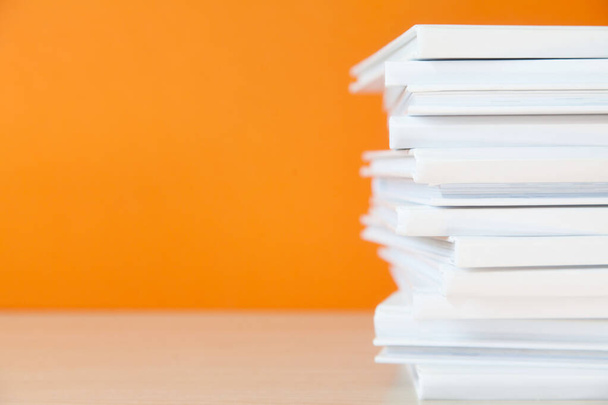 Stack of white books on colorful background.  - Photo, Image