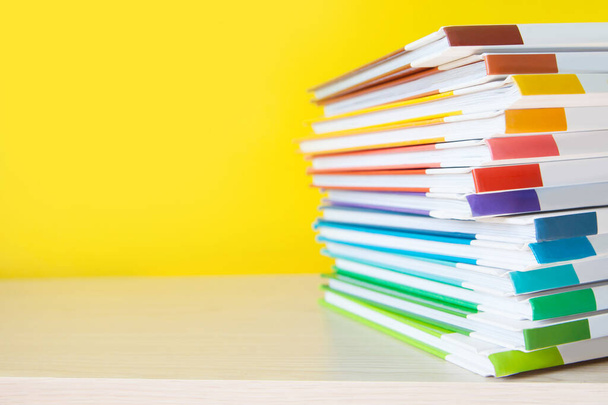Stack of colorful books on color background.  - Photo, Image