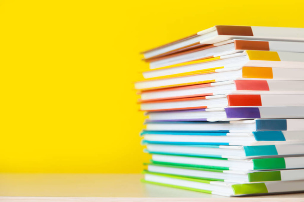 Stack of colorful books on color background.  - Foto, imagen