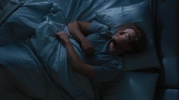 Top View of Handsome Young Man Sleeping Cozily on a Bed in His Bedroom at Night. Video Footage with Vertical Screen Orientation 9:16 - Filmagem, Vídeo
