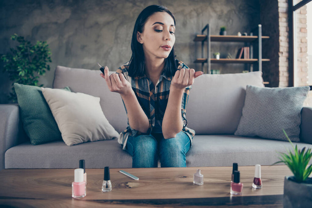 Photo of pretty lady made correction finger nails applying final polish coat blowing helping dry wear casual clothes sitting cozy sofa apartment indoors - Fotografie, Obrázek