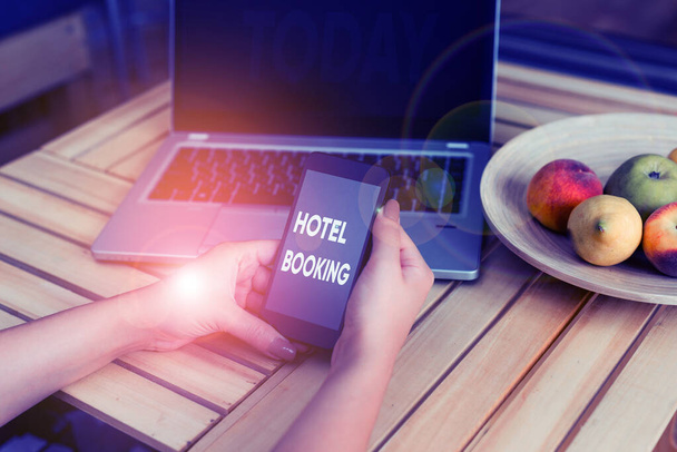 Conceptual hand writing showing Hotel Booking. Business photo showcasing Online Reservations Presidential Suite De Luxe Hospitality woman with laptop smartphone and office supplies technology. - Photo, Image