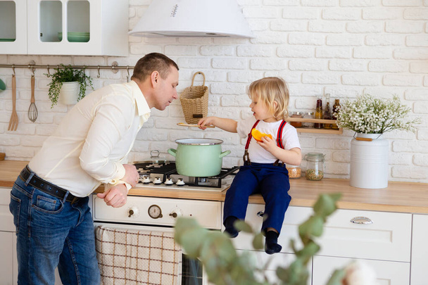 Dad and son cooking soup in pan. - Fotoğraf, Görsel