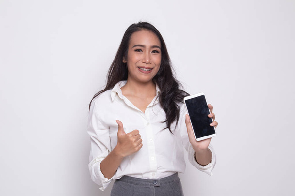 Young Asian woman show thumb up  with mobile phone. - Foto, imagen