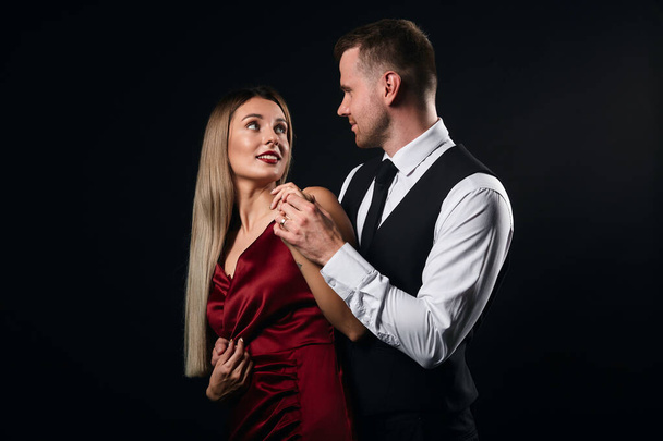 young attractive man and woman in chic clothes dancing together at club - Photo, image