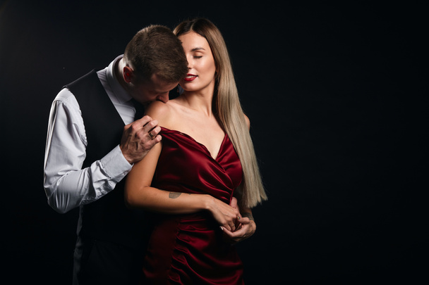 young elegant man kissing his wife, smelling her tan - Фото, изображение