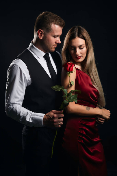 elegant handsome man giving his lady a rose on St.Valentines day - Fotoğraf, Görsel