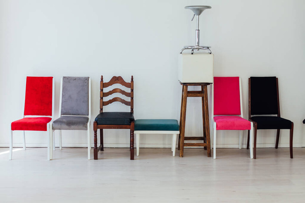 many different chairs stand in the white room - Valokuva, kuva