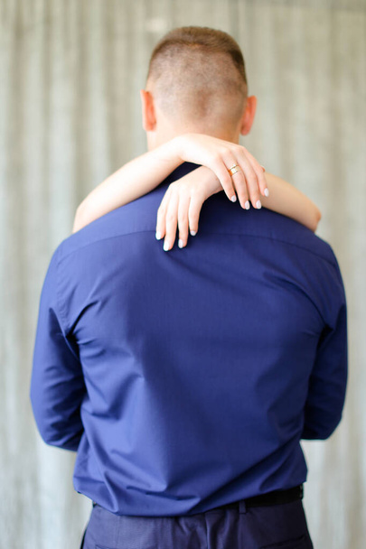 Back view of female hands hugging man. - Fotoğraf, Görsel