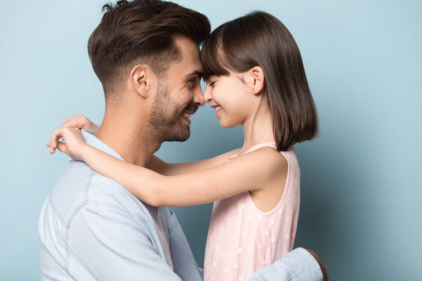Loving dad and preschool daughter hug touching noses - Foto, immagini
