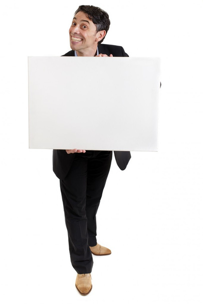 Geschäftsmann mit kitschigem Grinsen hält ein Schild in der Hand - Foto, Bild