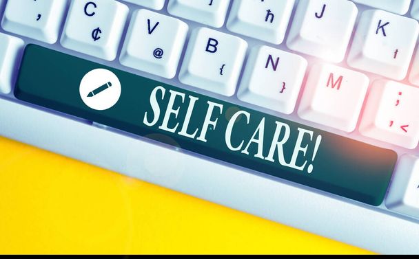 Writing note showing Self Care. Business photo showcasing practice of taking action to preserve or improve ones own health White pc keyboard with note paper above the white background. - Photo, Image