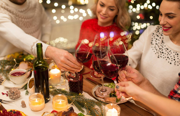close up of friends with wine celebrate christmas - Zdjęcie, obraz