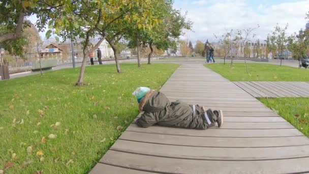 Infant boy falls on a wooden walkway - Materiaali, video