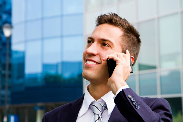 Portrait of a young businessman talking on the phone  - Fotografie, Obrázek