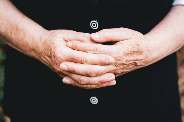 Older woman holding hands interlocked fingers. Elderly people concept - Zdjęcie, obraz