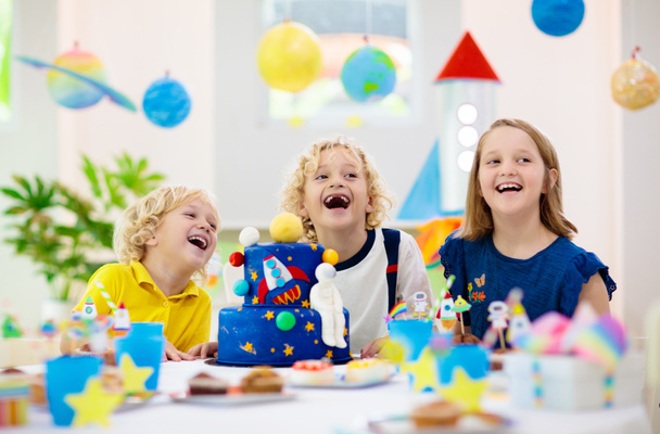 Kids space theme birthday party with cake. - 写真・画像