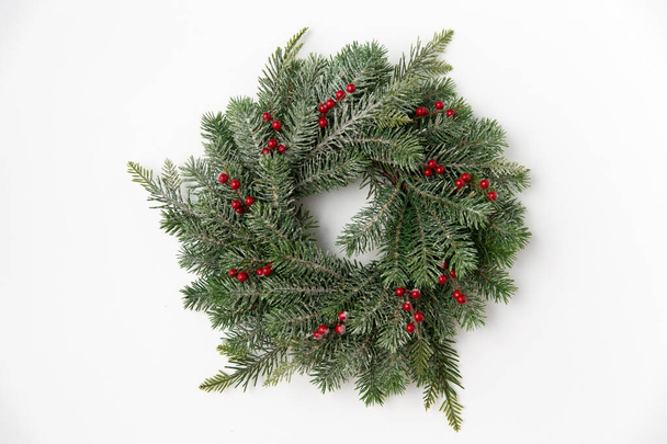 christmas wreath of fir branches with red berries - Фото, зображення