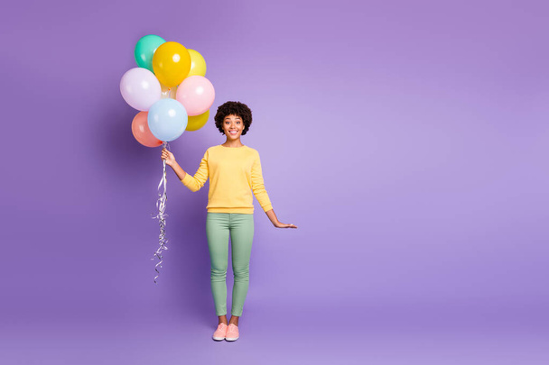 Full length photo of cheerful positive wavy hair afro american girl hold baloons gift for her anniversary celebration wear casual style outfit isolated over violet color background - Photo, Image