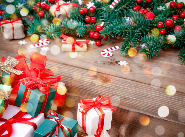 Christmas background with decorations and gift boxes on wood - 写真・画像