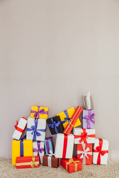 multi-colored gifts for the holiday on a gray Christmas background - Foto, Imagen