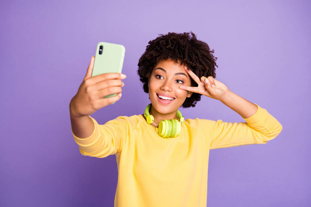Close-up portrait of her she nice attractive lovely cheerful cheery playful wavy-haired girl taking making selfie showing v-sign party isolated on violet purple lilac pastel color background - Foto, Imagen