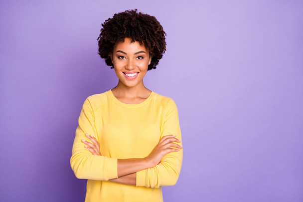 Photo of trendy sweet pretty attractive young representative of business people community standing confidently with arms crossed smiling toothily wearing yellow sweater isolated over purple pastel - Fotó, kép