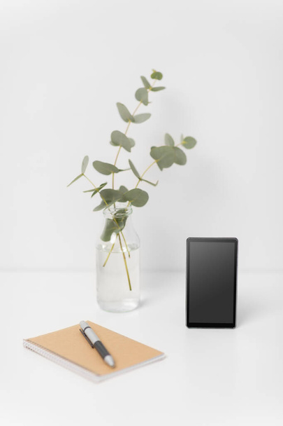 smartphone with black screen on white office table - Fotografie, Obrázek